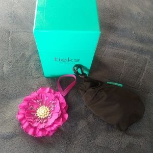 Empty Tieks box, shoe bags, and dark purple flower topper